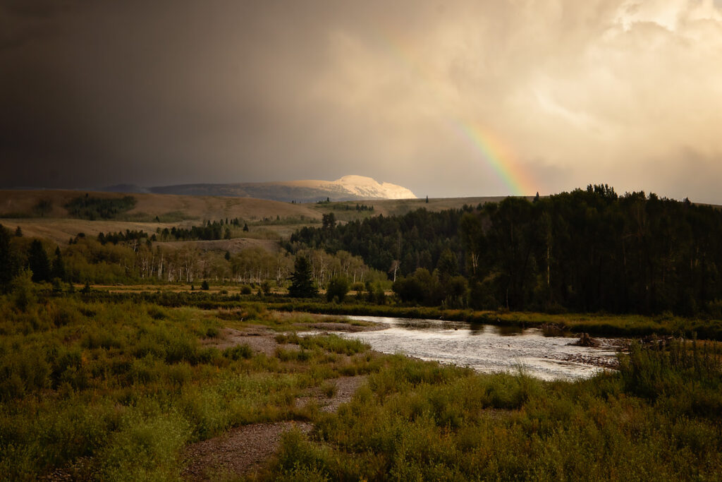 A photo of the sleeping indian mountain in Grand Teton with a rainbow over it.