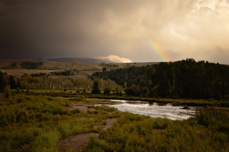 A photo of the sleeping indian mountain in Grand Teton with a rainbow over it.